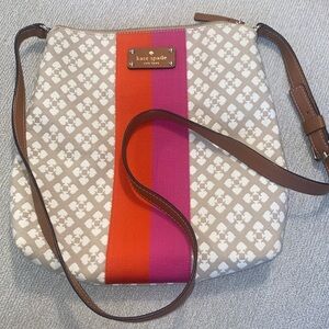 Kate Spade tan purse with red and pink accent.